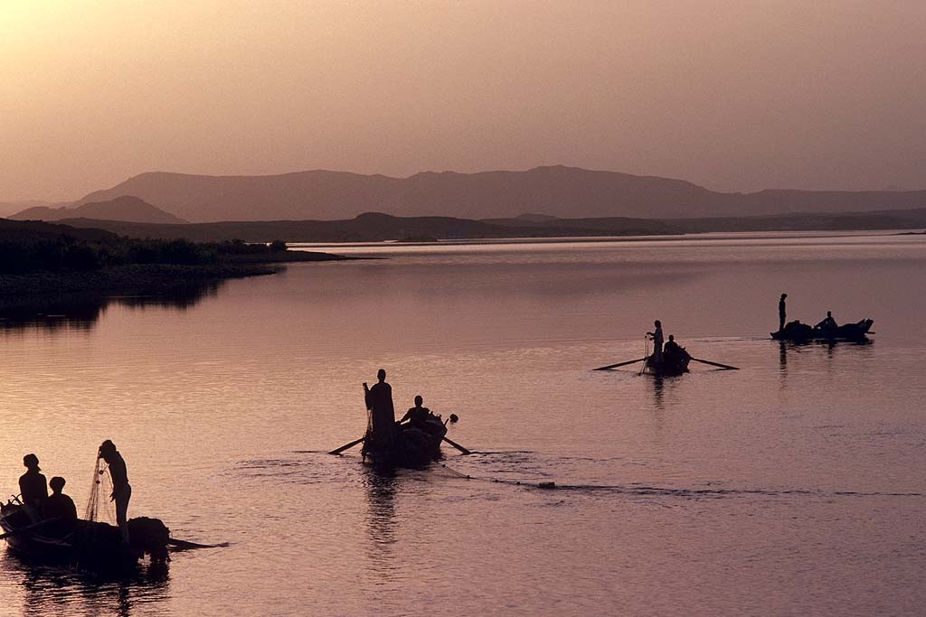 Tor Eigeland - Fishermen casting their nets at dawn on Lake Nasser, also called the High Dam Lake. W3366